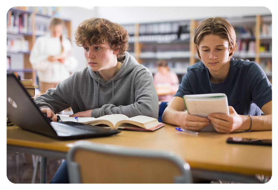 Kid sitting in school on computer.