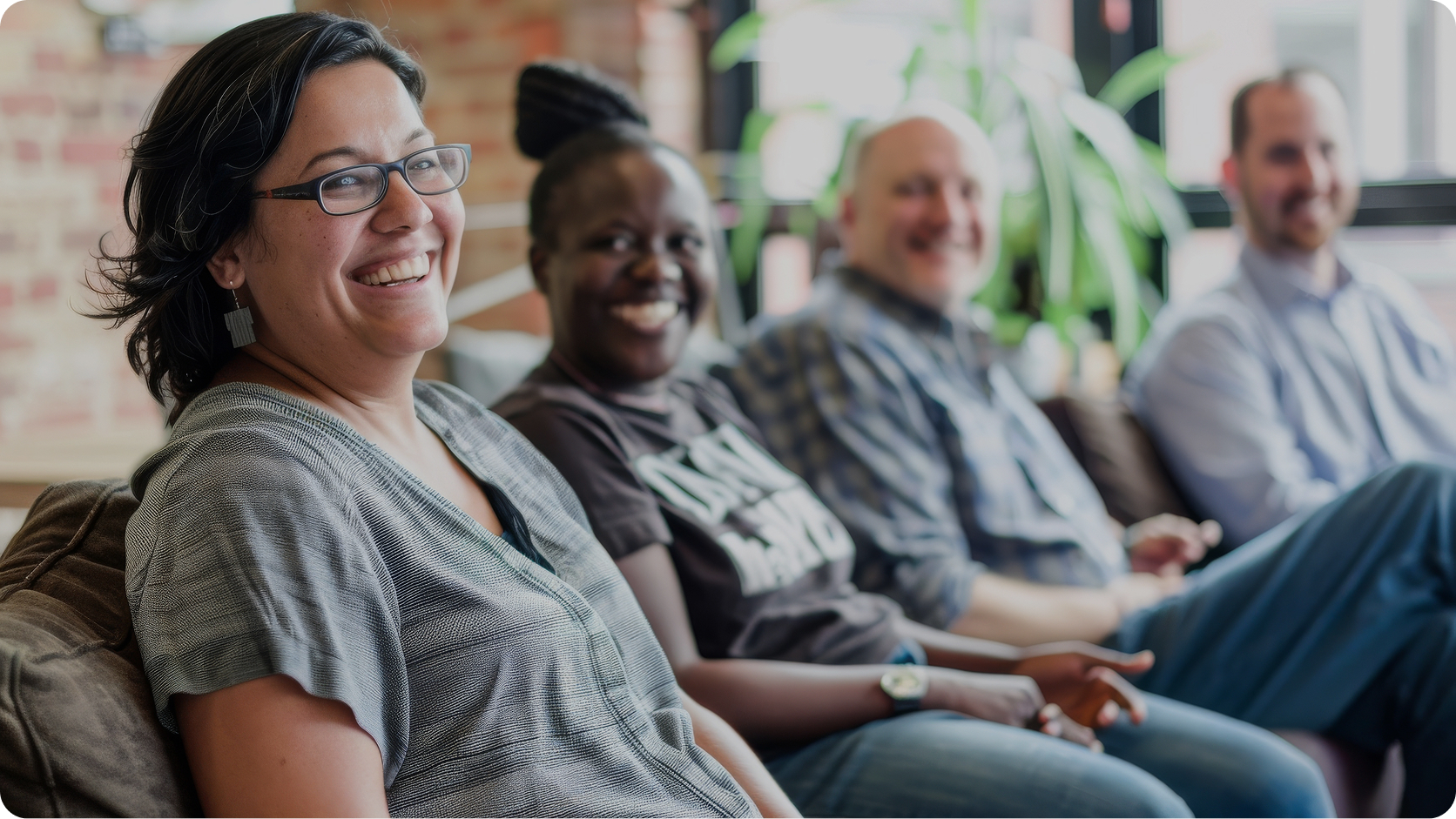 People sitting in a meeting laughing and smiling.